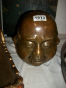 A large bronze 4 faced Buddha head