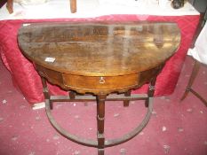 A 'D' shaped oak table with single drop leaf