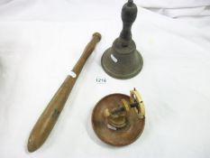 A brass bell, nutcracker and truncheon