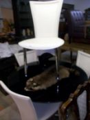 A glass top table and 4 retro style chairs