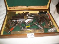 A tool box containing approximately 30 old tools
