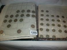 A folder of coins including some silver