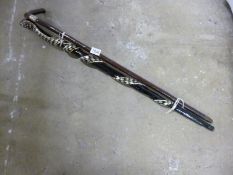 A hazelnut walking stick with unmarked silver band and a snake walking stick with mother of pearl
