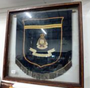 A framed Royal Army Ordnance Corps banner