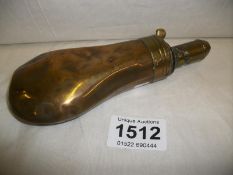 A brass powder flask