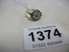 A 9ct gold ring set green stones (size I)