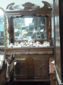 A carved mirror backed sideboard