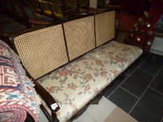 A cane backed sofa