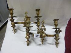 A pair of ornate Victorian brass double wall mounting candleholders