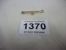 An 18ct rose gold bar brooch set diamonds