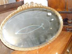 An oval gilt framed mirror