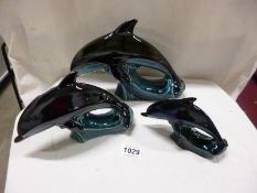 A set of 3 Poole pottery graduated dolphins