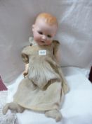 A German porcelain headed doll with composition body marked A M, Germany 391/9K
