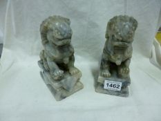 A pair of carved stone Dogs of Foo