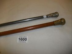 An old walking cane and a silver mounted walking stick