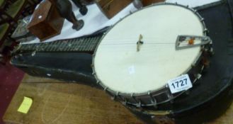 A five string banjo, case distressed