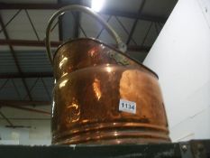 A copper coal scuttle