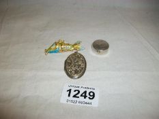 A silver pill box, silver locket and articulated enamel fish