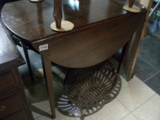 A Victorian mahogany drop leaf table on tapered legs