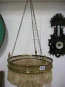 A brass fringed ceiling light
