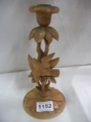 A carved wood candlestick