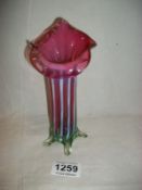 A cranberry and vaseline glass vase