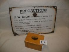 A W. Bombs enamel sign and a Mauchlin ware money box, Morecombe
