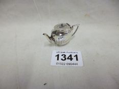 A miniature silver teapot