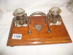 An oak desk stand with inkwells