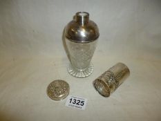 A silver topped bottle (no stopper), a silver cap and a silver bottle collar