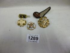 An enamel sweetheart and other military badges