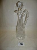 A cut glass oil/vinegar decanter