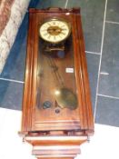 A mahogany wall clock