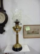 A brass oil lamp with later shade