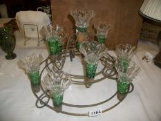 A green glass and brass table centrepieces (some trumpets a/f)