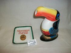 A Guinness toucan jug and a Guinness ashtray