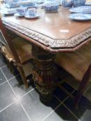A Victorian oak Jacobean style table on heavy carved legs and with 5 leaves
