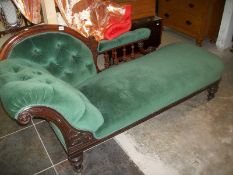 A mahogany chaise longue upholstered in green