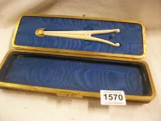 A vintage expanding glove box complete with original glove stretchers