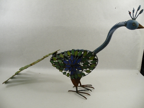 A mid 20th C formed metal peacock decorated with glass pieces 90cm long