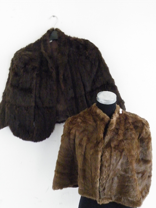 Two ladies fur capes, one in dark brown the other light
