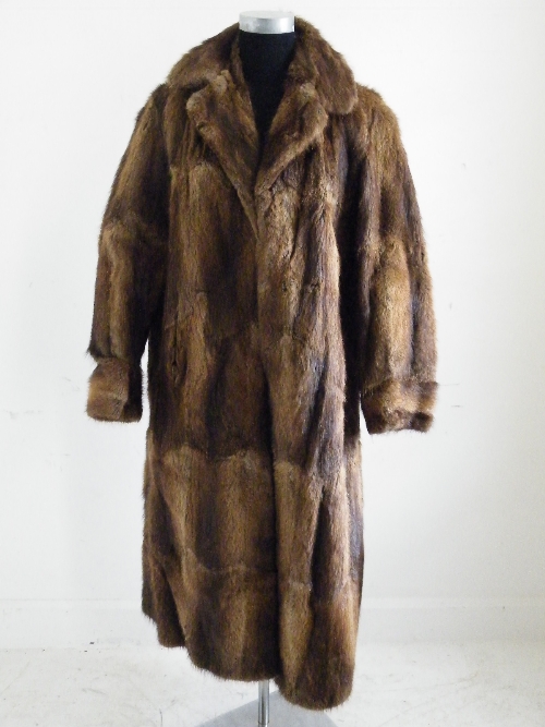 A ladies full length brown fur coat