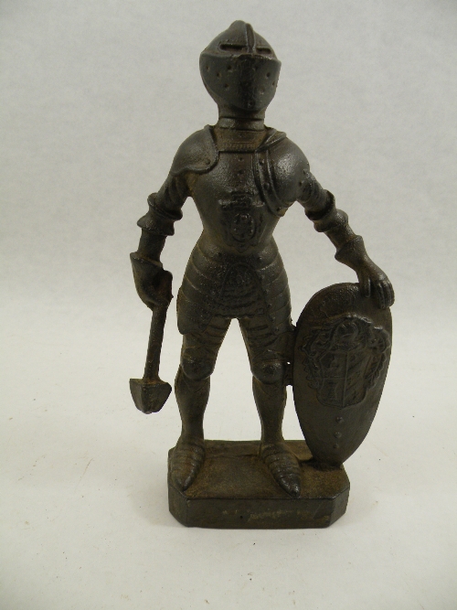 A 19th C cast iron figure of a knight in armour holding a club and shield, possibly German 29cm high