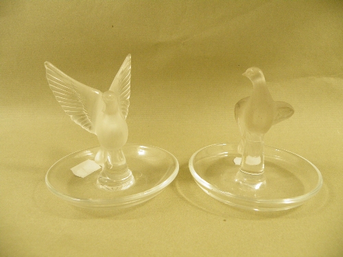 Two Lalique glass pin trays, the central column on each moulded with a dove, etch mark to base,