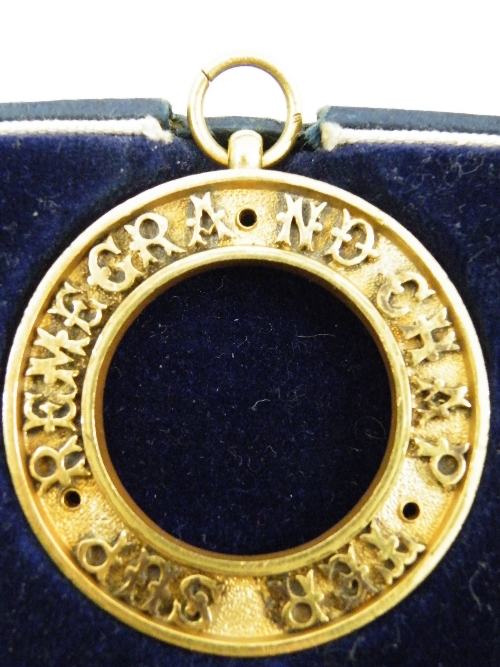 A boxed Masonic medal by Spencer & Co, London, centre missing, the outer ring inscribed REMEGRAND