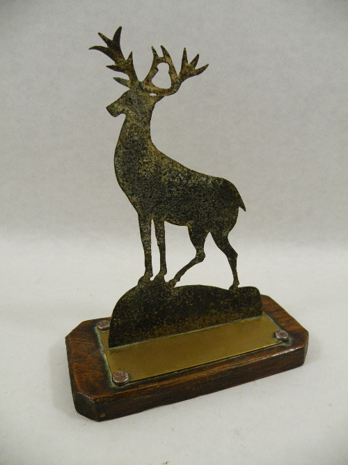 Trench Art: An early 20th Century brass silhouette of a stag riveted onto an oak canted base - one