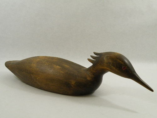 A mid 20th Century carved fruitwood model in the style of a decoy duck as a Goosander with glass