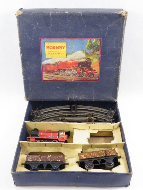 A Hornby Meccano tinplate lithographed red engine (minus tender) and two LMS goods carriages and