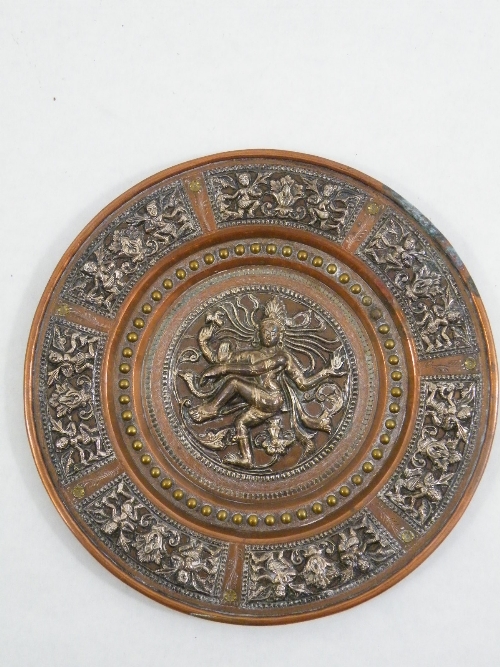 Indian silver, copper and brass circular plaque , the central relief panel depicting Shiva as