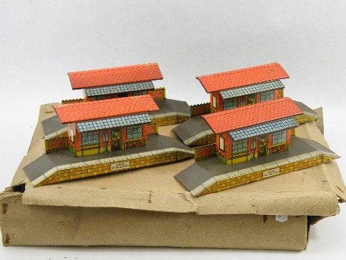 Four Wells Brimtoy lithographed tinplate O gauge railway stations 25cm wide.